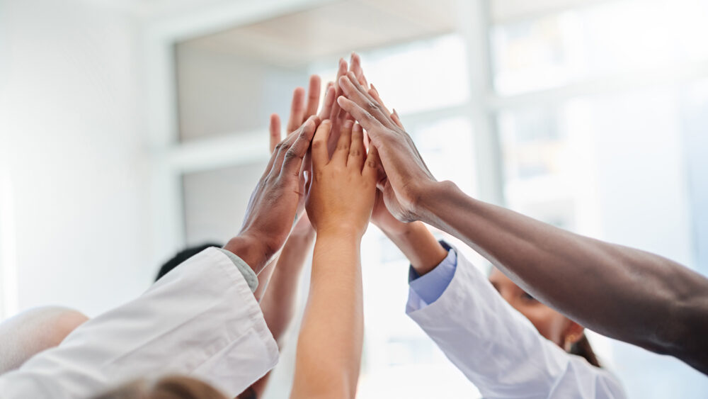 diverse group of doctors high-fiving