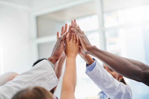 diverse group of doctors high-fiving